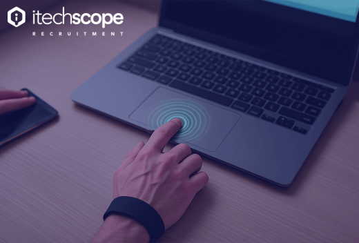 Hand on touch pad of open laptop.